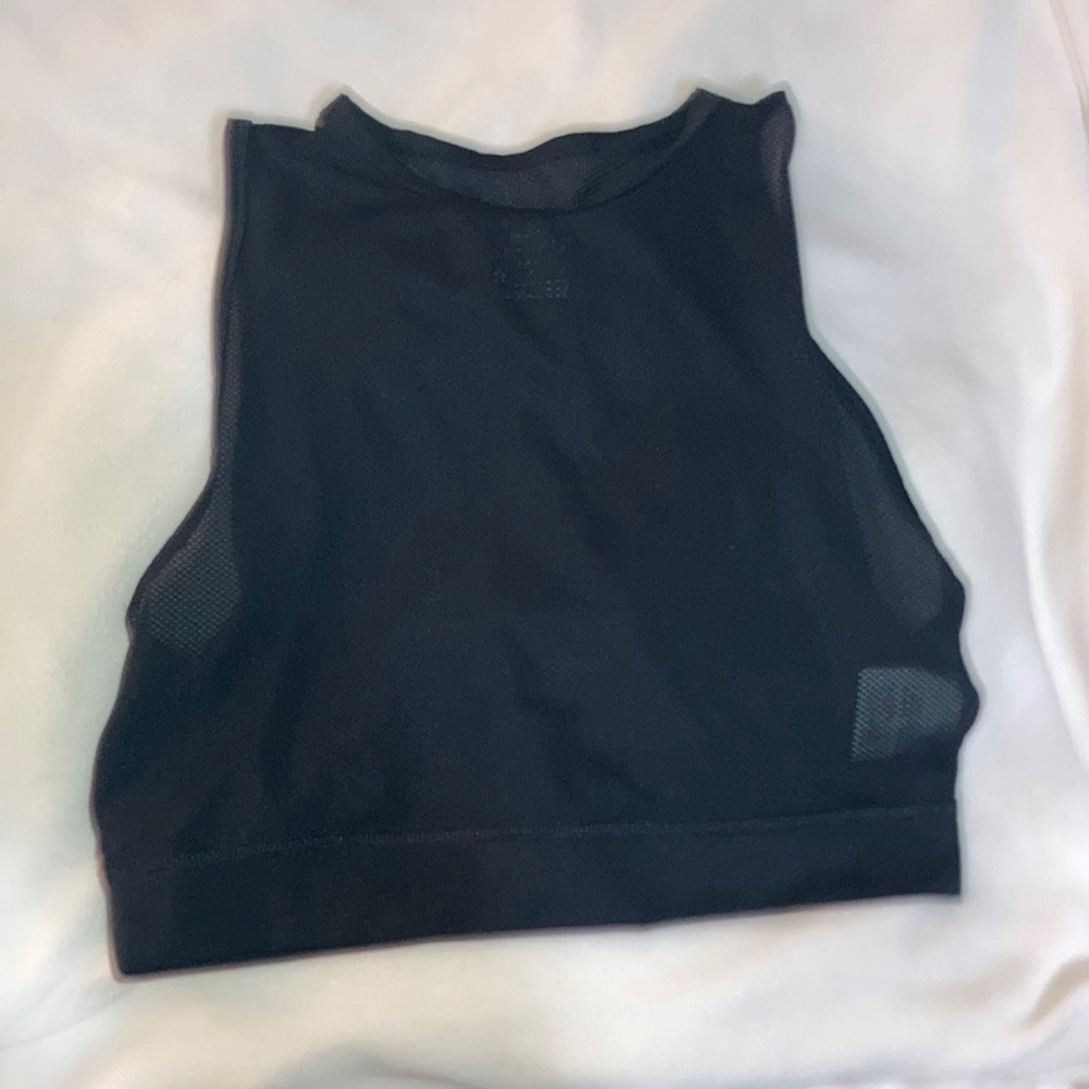 See through workout shirt(mesh), and it is cropped. In perfect condition.